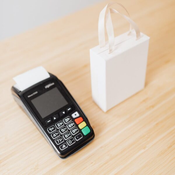 payment terminal beside a white carton box